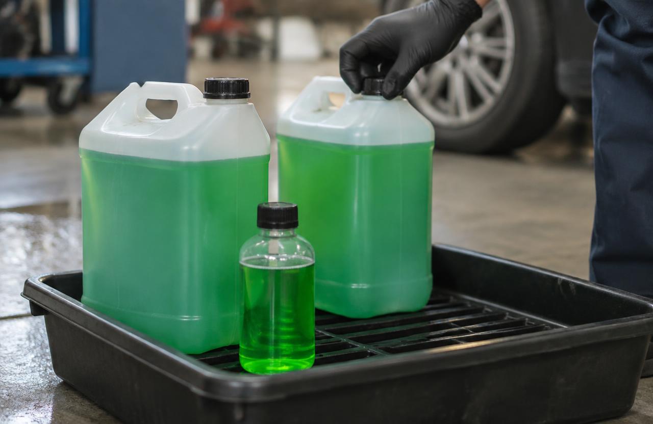 Antifreeze jerricans grouped in containment trays